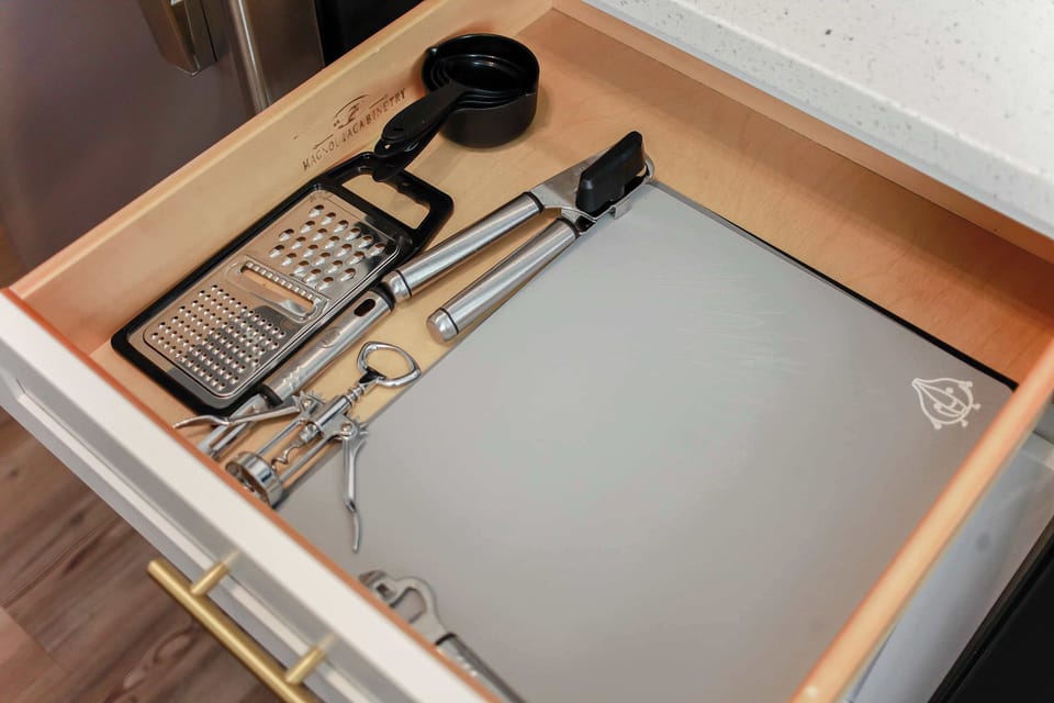 Kitchenware in drawer.