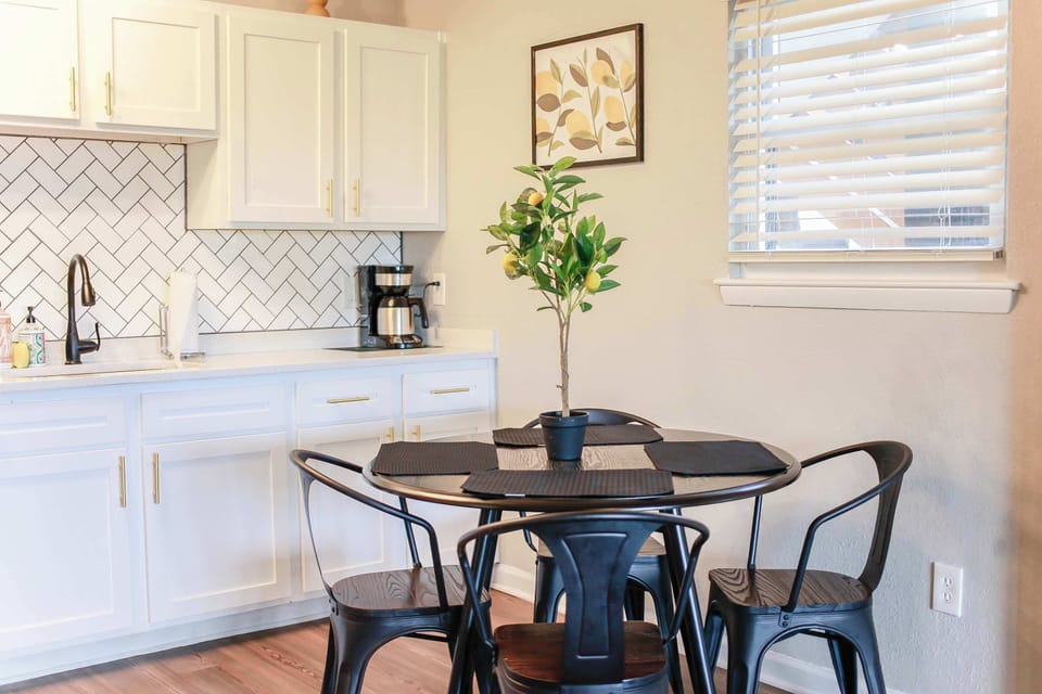 Dining area and kitchen sink with cabinets.