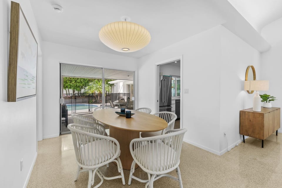 A chic extended dining space for 6, complete with contemporary lighting for a perfect ambiance.