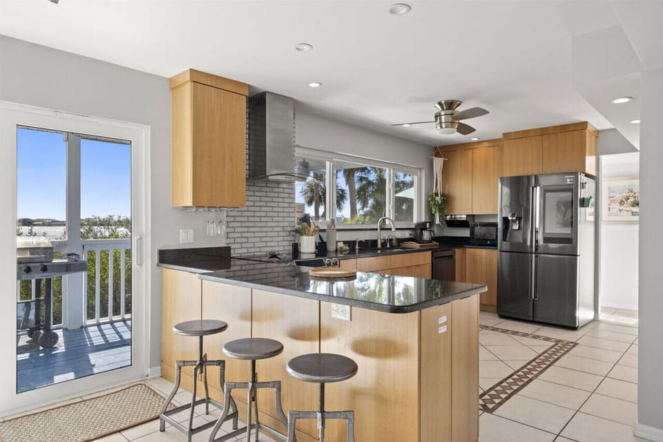 Spacious kitchen with a breakfast bar offering comfortable seating for 3—perfect for morning coffee, quick meals, or keeping the cook company.