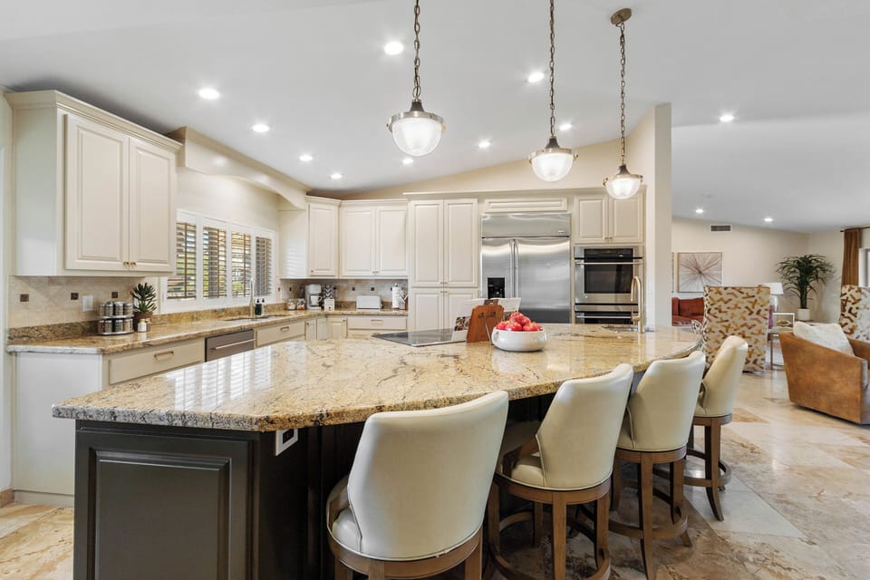 Chef's Kitchen with Stainless-steel appliances, including a sleek flat top electric stove and double ovens