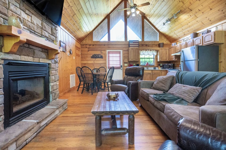 Inviting space with wood accents, comfy seating, and sunlight streaming through tall windows!