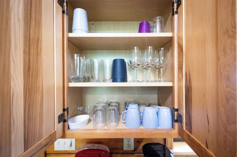 Kitchen: Fully stocked with a colorful array of glassware, perfect for any type of drink.