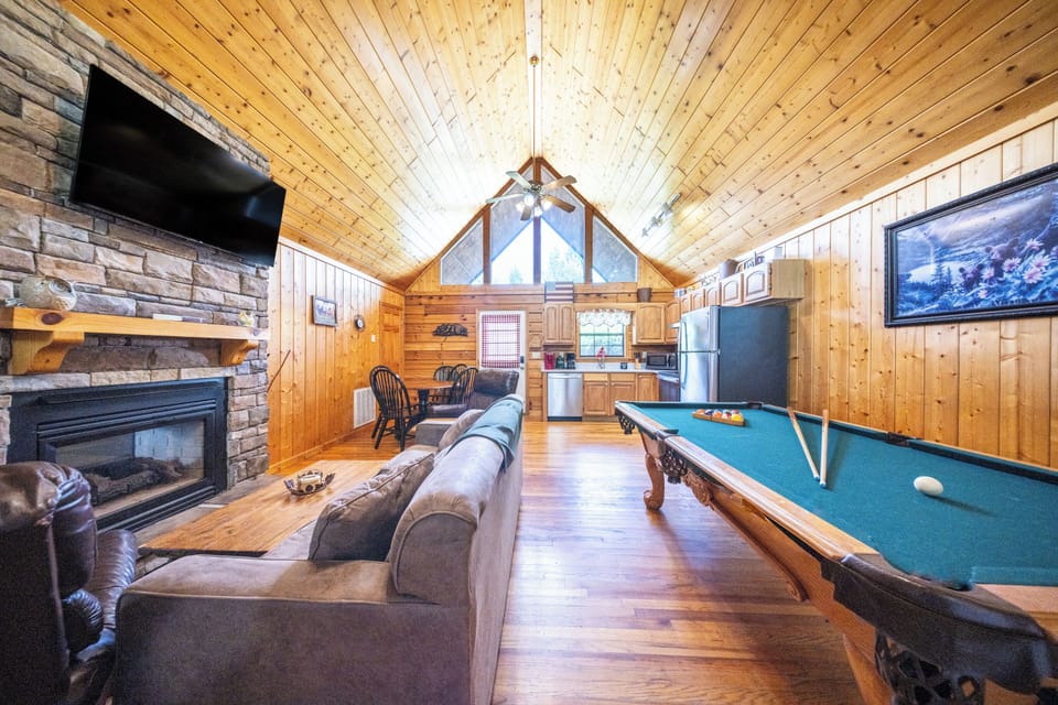 Living Room: Gather around the fireplace and challenge friends to a game of billiards!