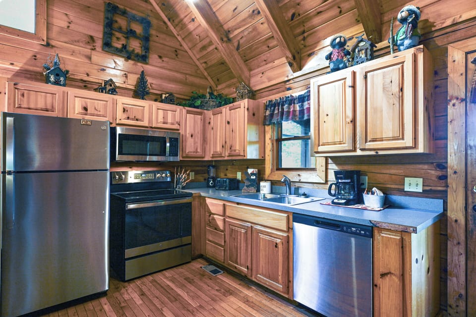 Cook and unwind in this cozy wood-paneled kitchen featuring stainless steel appliances.