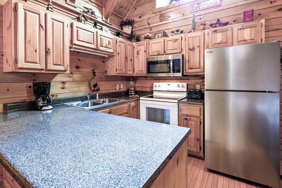 Kitchen: Modern appliances and inviting wood accents await your culinary adventures!