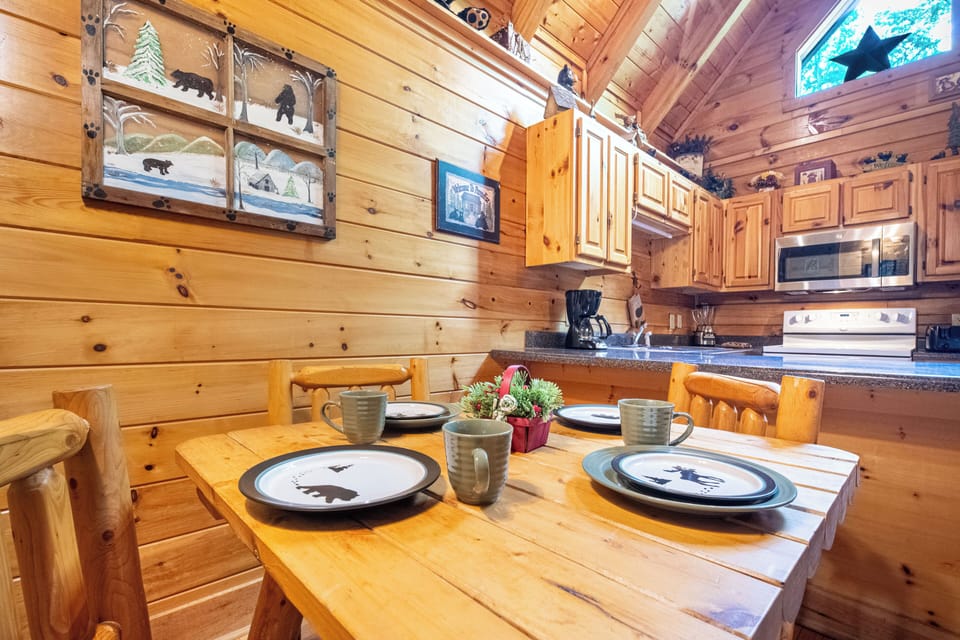 Dining Area: Unwind with meals at this charming log cabin table, surrounded by rustic charm!