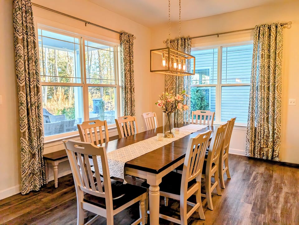 51 Beach Club Avenue - Bright Dining - A detailed view of the dining table under natural light, highlighting the elegant coastal decor and its connection to the open floor plan.