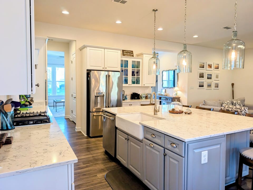 51 Beach Club Avenue - Kitchen Interior - Detailed view of the expansive granite countertops and farmhouse sink, highlighting the modern finishes and abundant natural light in this culinary workspace.