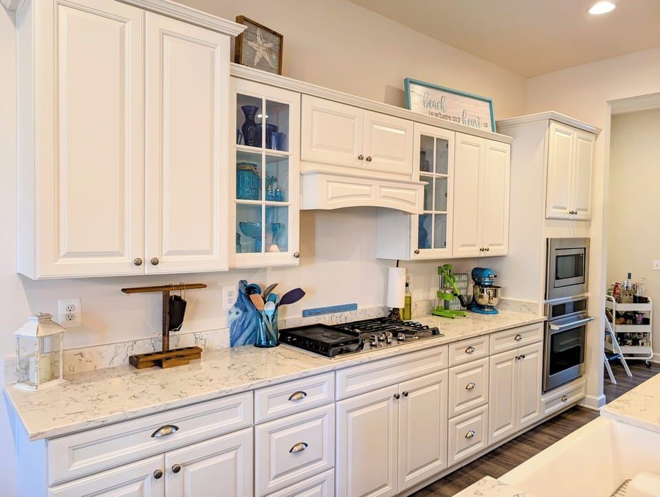 51 Beach Club Avenue - Gourmet Kitchen - Modern kitchen featuring a high-end gas cooktop, sleek white cabinetry, and elegant quartz countertops, designed for the home chef.