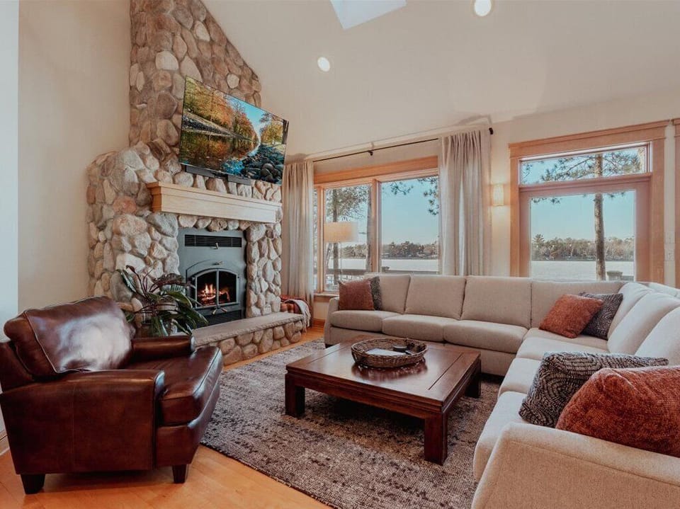 Lakeside living room w/ wood burning FP and sweeping views of Dagget Lake