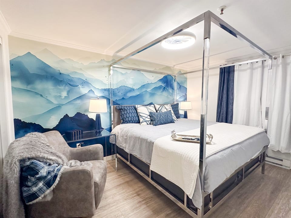 The master KING bedroom is themed for your mountain getaway, and features a Casper mattress, designer bed, writing desk, comfy swivel chair, and 55-inch smart TV.