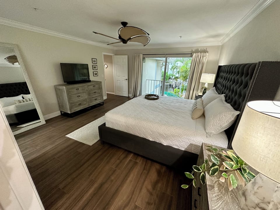 Master bedroom with balcony and water view