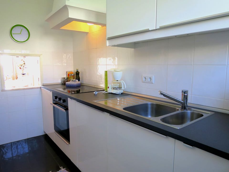 Modern kitchen with service hatch to dining area of livingroom