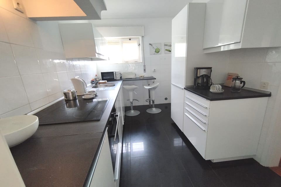 Kitchen with breakfast bar and laundry room on right at the far end