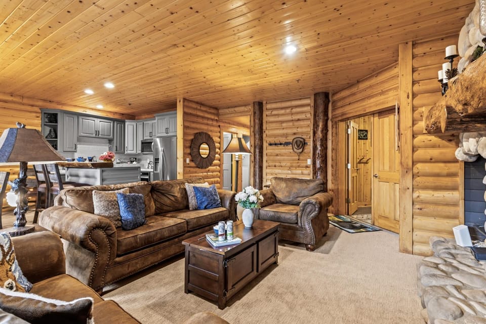 Flow from the living area to the dining space with ease in this open, wood-paneled layout.
