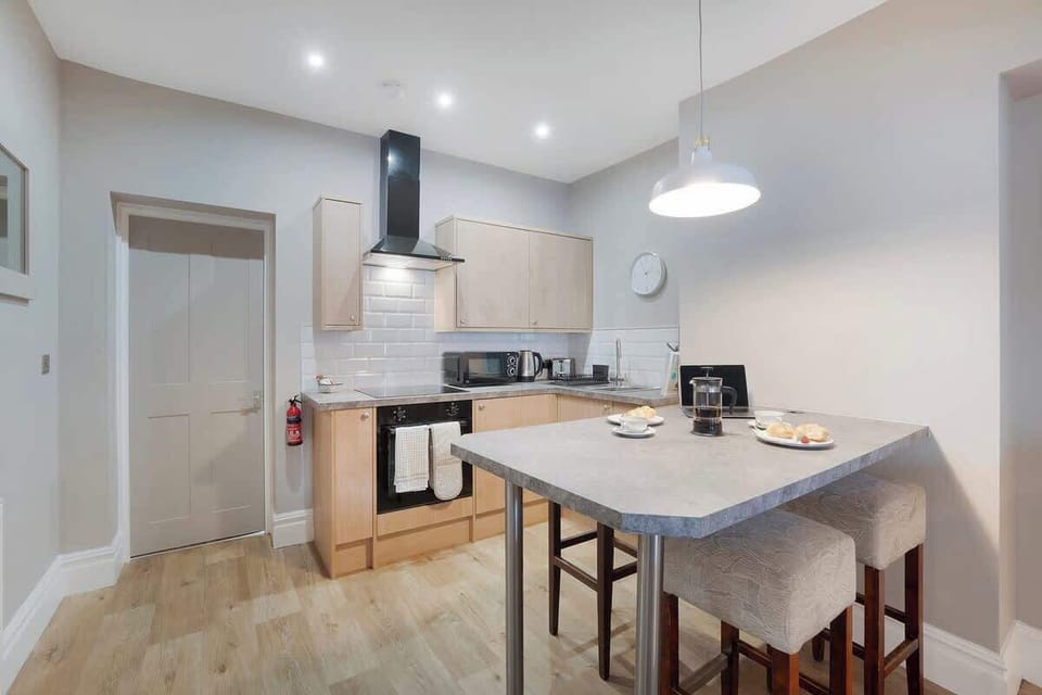 Kitchen equipped with all essentials, including a washer & dryer, oven, fridge and full cookware set.