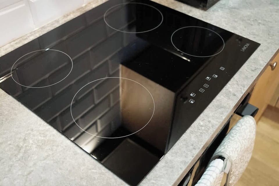 Kitchen equipped with all essentials, including a washer & dryer, oven, fridge and full cookware set.