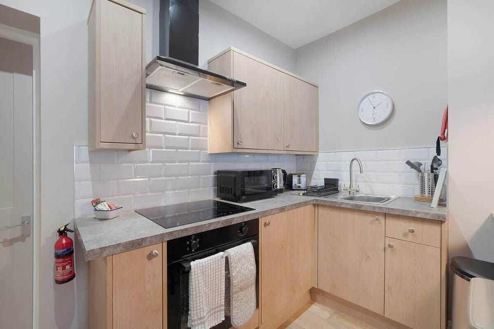 Kitchen equipped with all essentials, including a washer & dryer, oven, fridge and full cookware set.