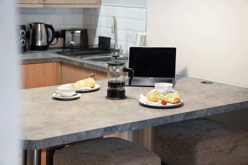 Kitchen equipped with all essentials, including a washer & dryer, oven, fridge and full cookware set.