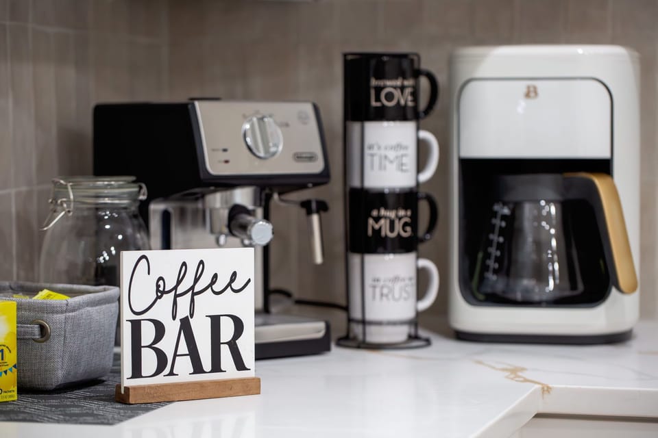 Coffee bar with De'Longhi Espresso Machine, and 14-cup regular coffee maker.