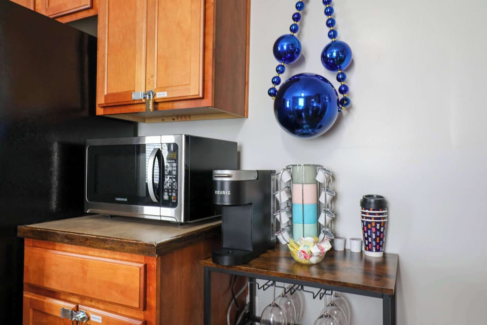 Kitchen featuring a full set of appliances, bar seating at the counter, and all the cookware, dishes, and utensils you could need.
