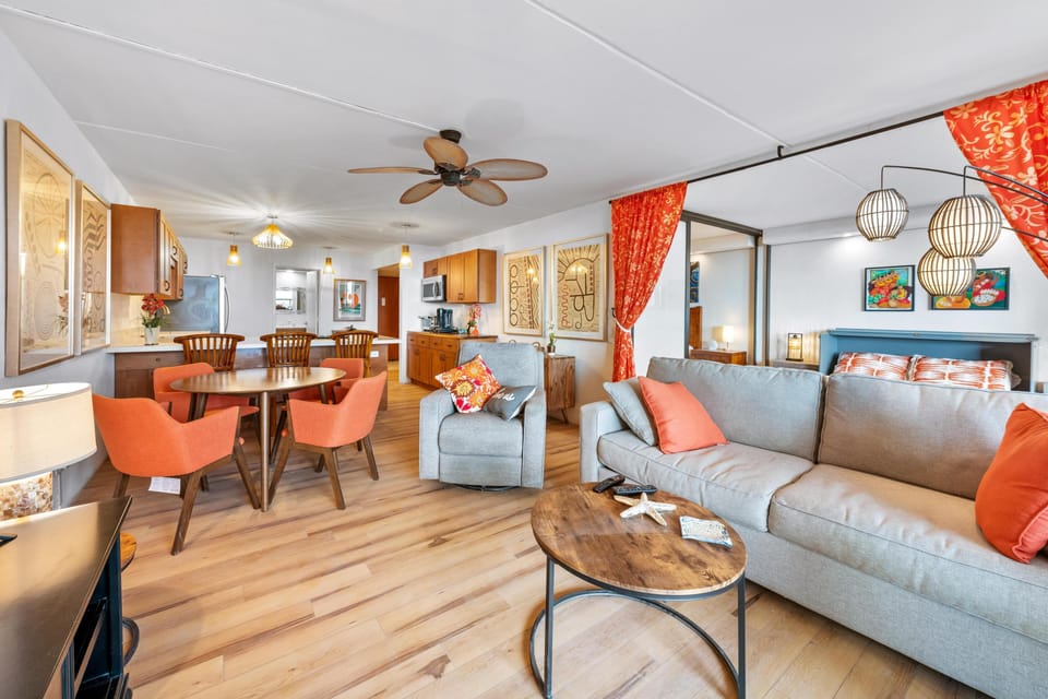 Comfortable living room with sofa sleeper & ceiling fan