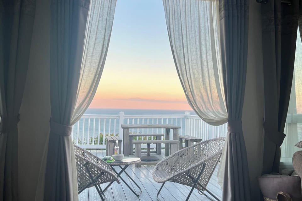 Living Room with double doors out on to Panoramic Seaview balcony 