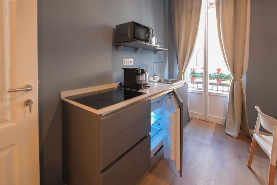Deluxe Quadruple Room, Balcony | Private kitchen | Fridge