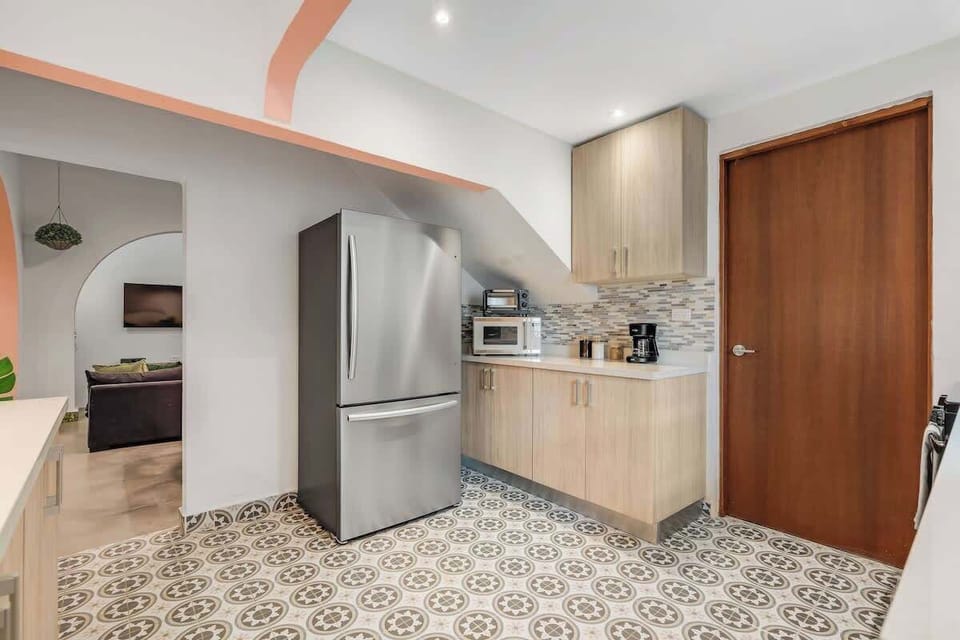 Modern kitchen featuring a full-size refrigerator.