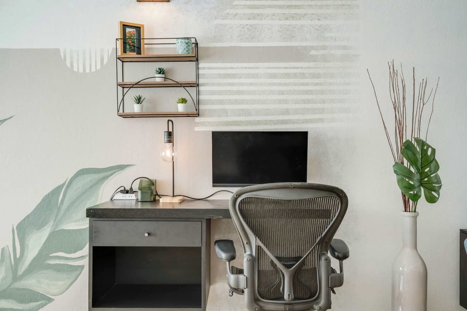 PC, desk and office chair. plants.