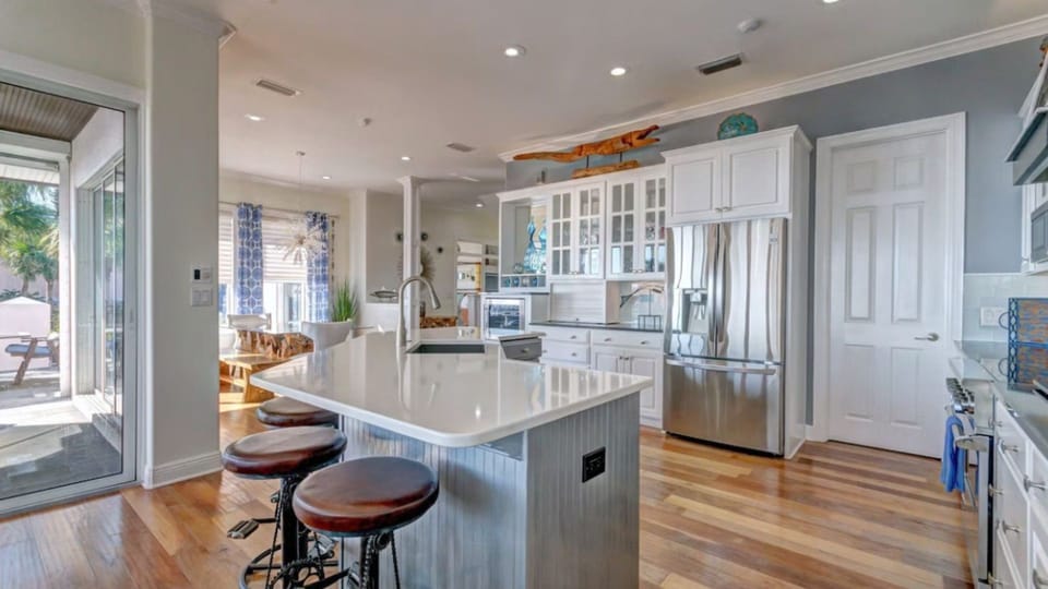 Your spacious kitchen invites culinary adventures with gleaming countertops, professional appliances, and a welcoming island perfect for morning coffee or evening conversations.