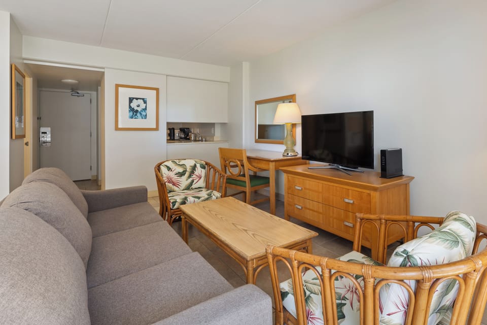 Your bright, welcoming living space features a comfy sofa, tropical-accented seating, and a kitchenette—perfect for unwinding after a day of island adventures.