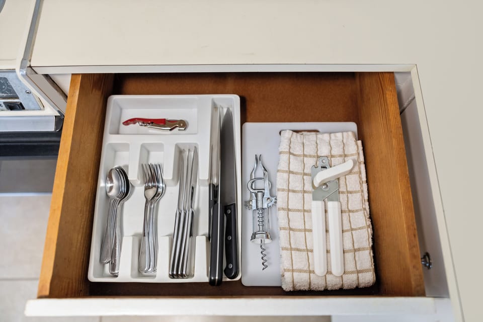 Well-organized drawer with utensils, wine opener, and kitchen tools—everything you need at your fingertips for easy meal prep.
