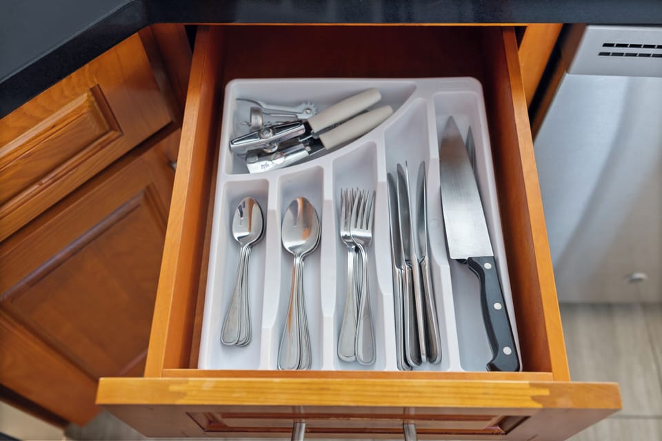 Your fully stocked kitchen includes quality utensils and tools neatly organized in custom drawer inserts, making meal prep a breeze during your stay.