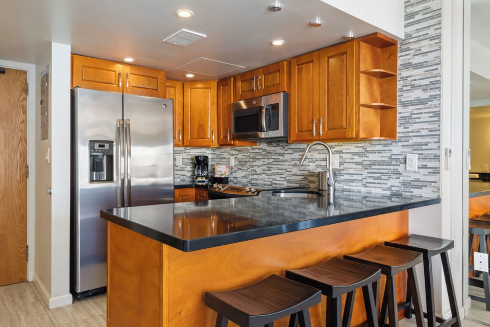 Your fully equipped kitchen features sleek granite counters, stainless steel appliances, and a breakfast bar where you can sip your morning coffee or gather with loved ones.