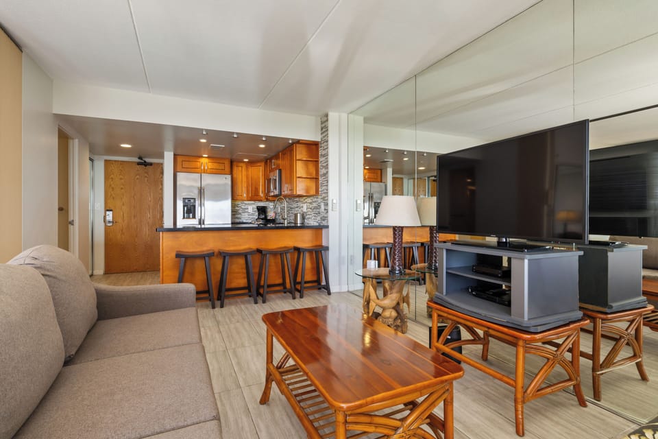 Unwind in this inviting open-concept living space featuring warm wood tones, modern amenities, and a fully equipped kitchen with stylish granite countertops—your perfect home away from home.