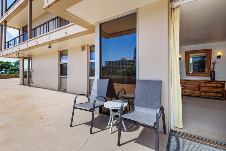 Step onto your private balcony where two chairs invite you to relax with morning coffee or evening wine, framed by tropical greenery and distant views.