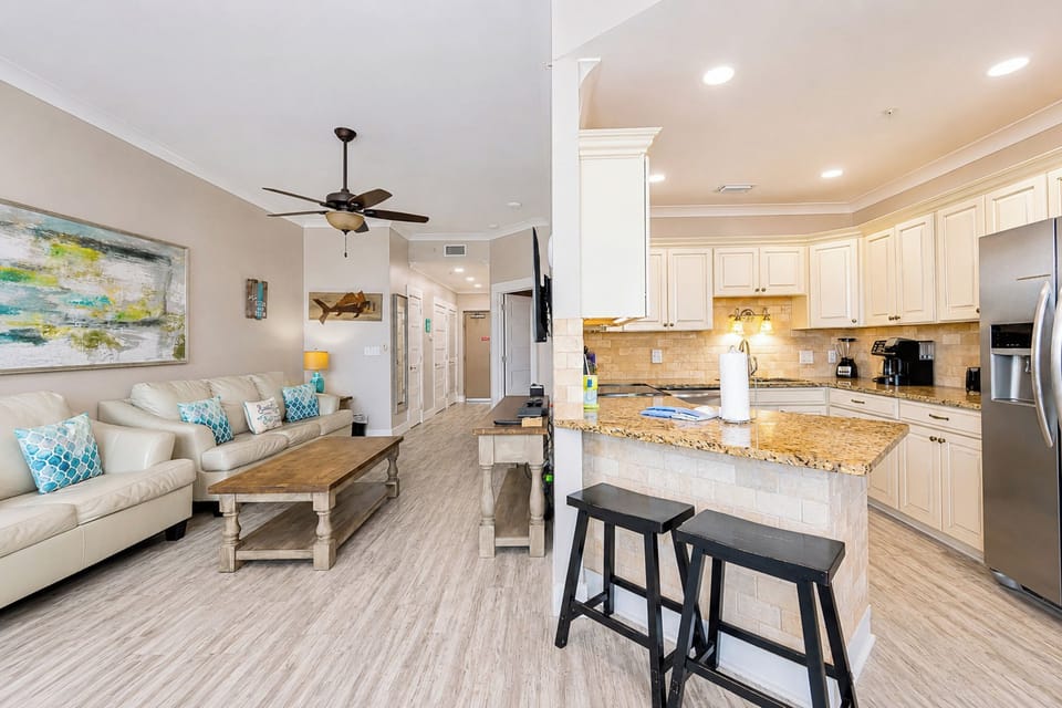 Enjoy meals at the round dining table surrounded by colorful artwork and natural light from the sliding doors