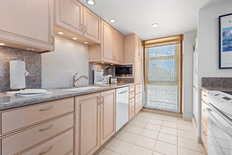 This well-appointed galley kitchen has everything you'll need to prepare your favorite meals. Ample counter space, modern appliances, and natural light make cooking convenient and enjoyable during your stay.