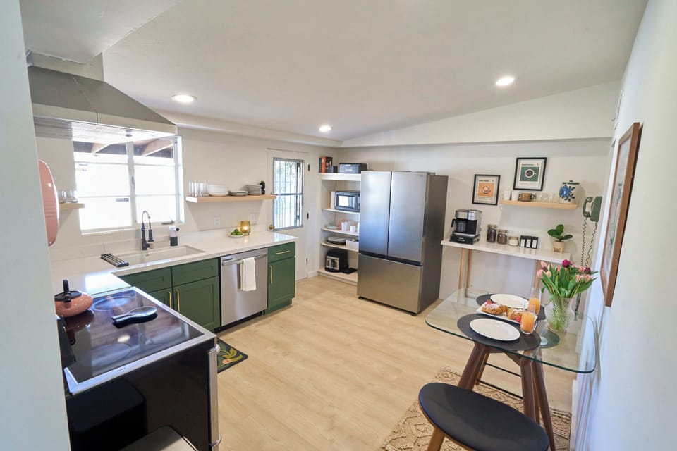 Open kitchen, floating shelves make dishes easy to find, breakfast nook