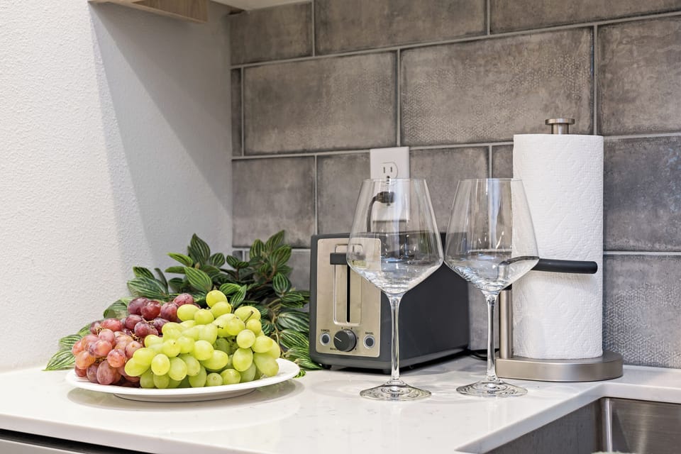 Simple pleasures—wine, grapes, and cozy elegance in the kitchen nook.