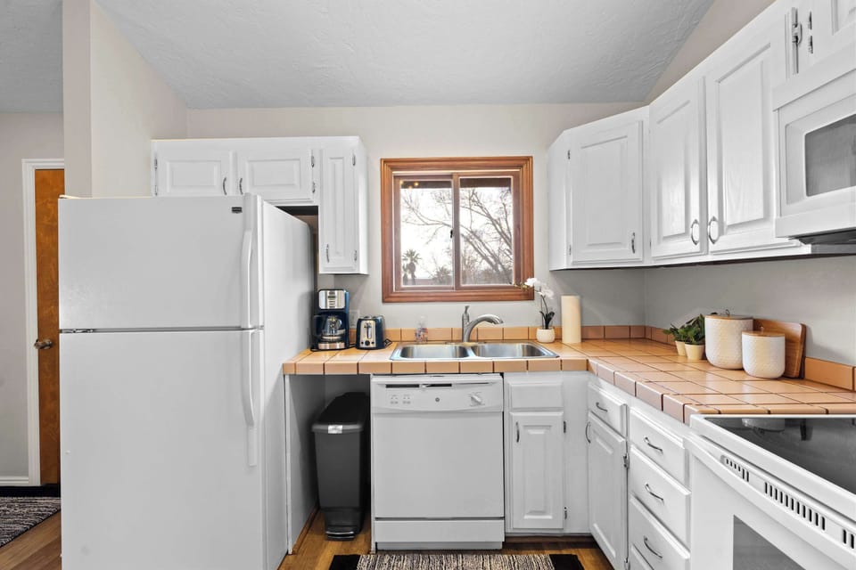 The airy, open kitchen offers ample space & all the comforts of home