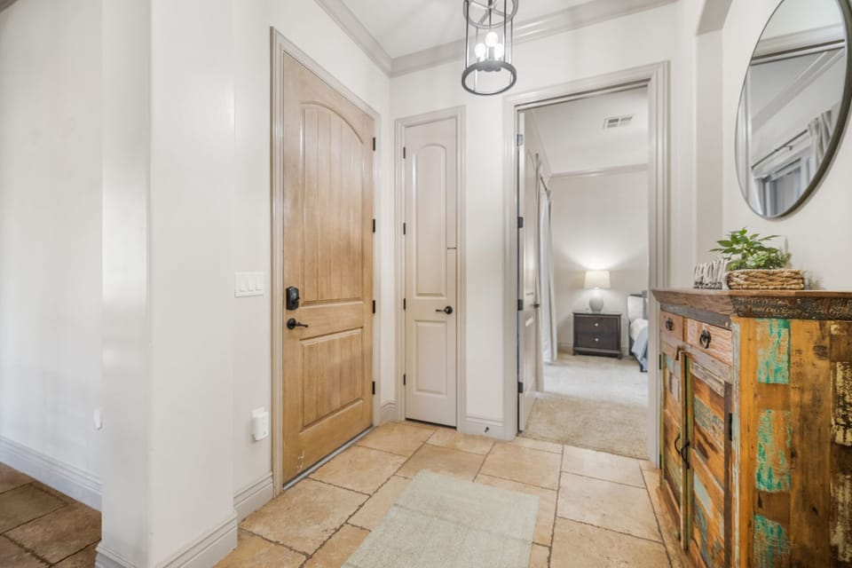 Master bathroom with dual sinks, spa tub, walk-in shower, and closet