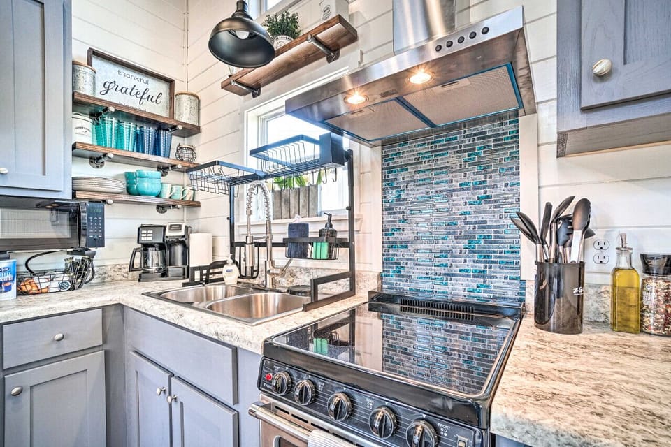 Stylish and fully stocked kitchen with modern appliances and a beautiful backsplash—everything you need for cooking up a delicious meal.