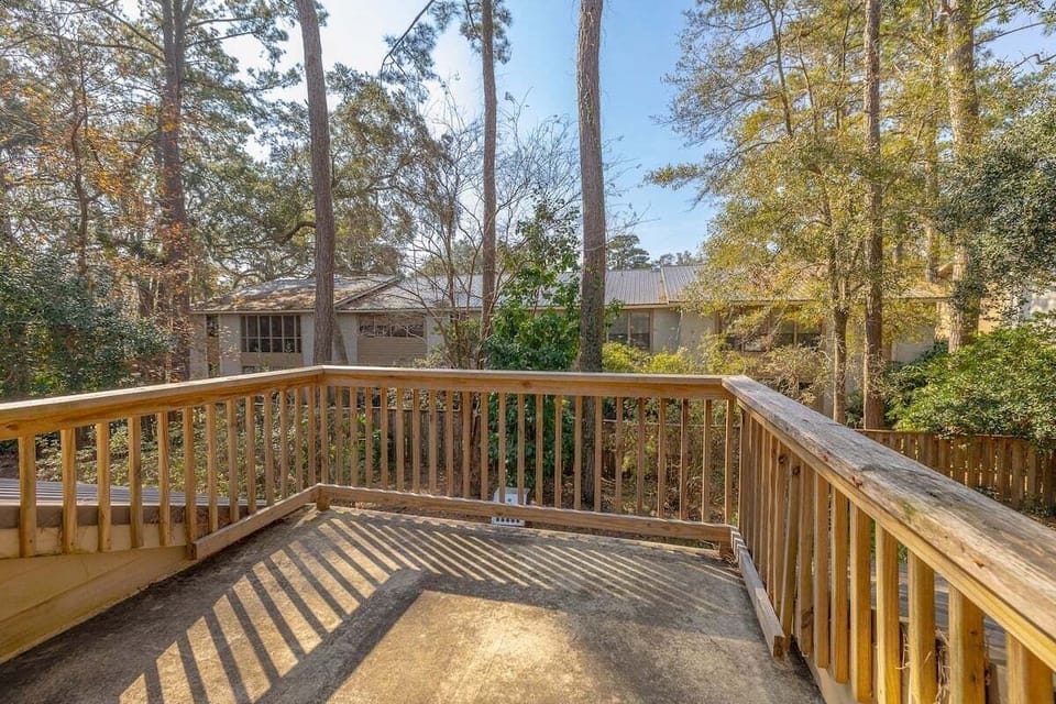 Wood deck overlooking wooded backyard and trees
