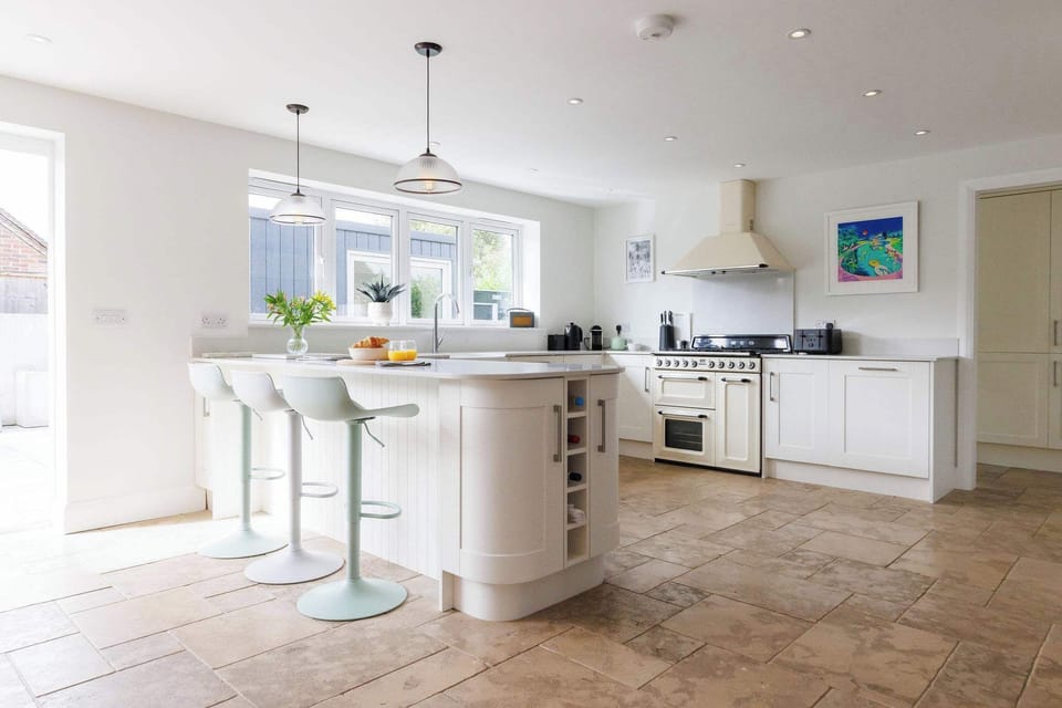 The open plan kitchen and dining, with breakfast bar, creates a fantastic space for families and friends to cook and socialise together.