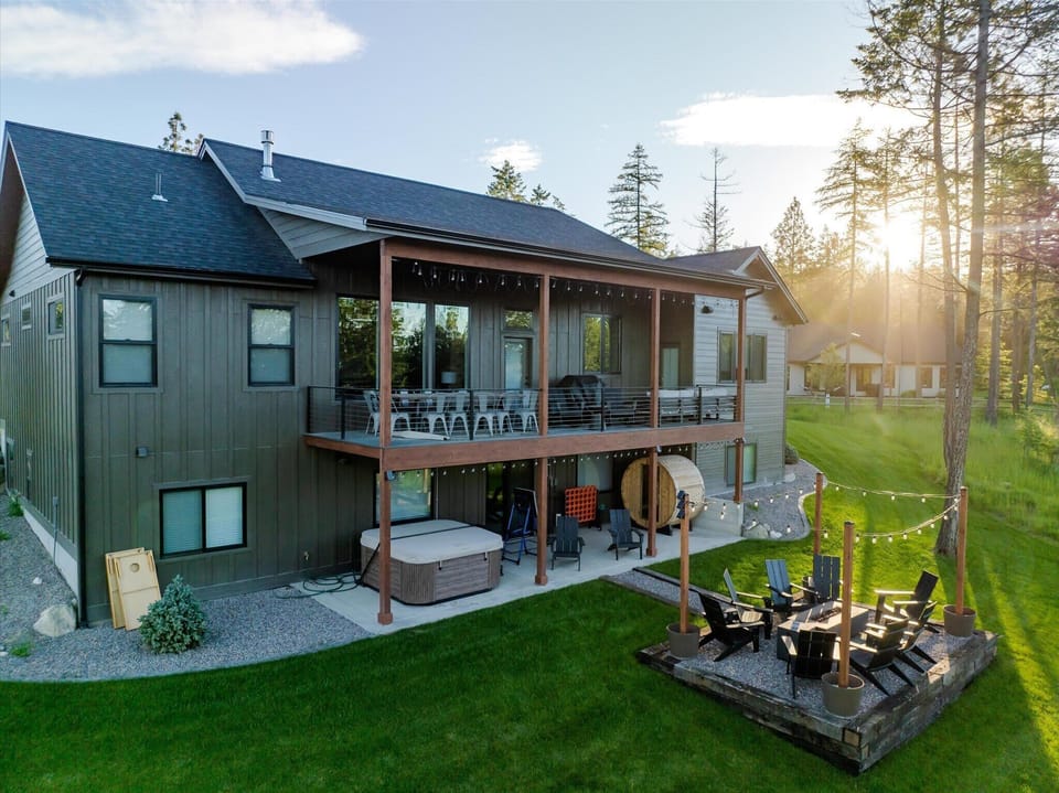 Everything you need, right outside your door. Hot tub, barrel sauna, fire pit, and a wraparound deck soaking in the Montana sun — your ultimate outdoor retreat awaits. 