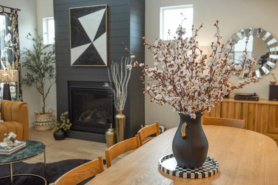 Dine with a view of the modern fireplace and cozy living room