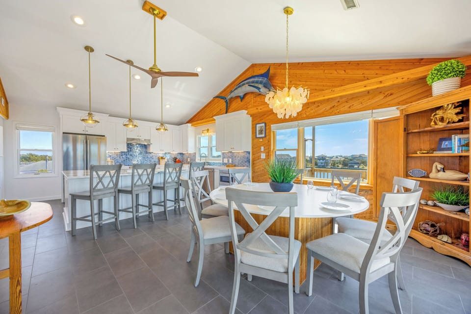 Gather around the spacious kitchen island or enjoy meals at the cozy dining table, where natural light and water views create the perfect setting for making memories together.